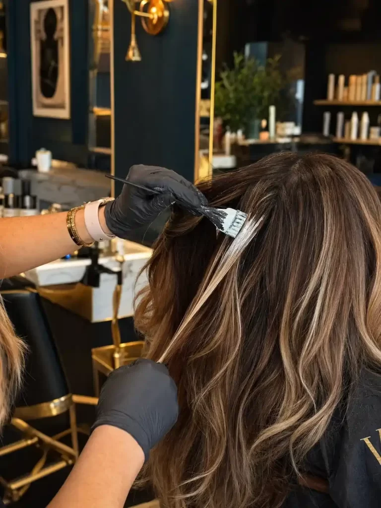 Hair color being applied during a salon color appointment